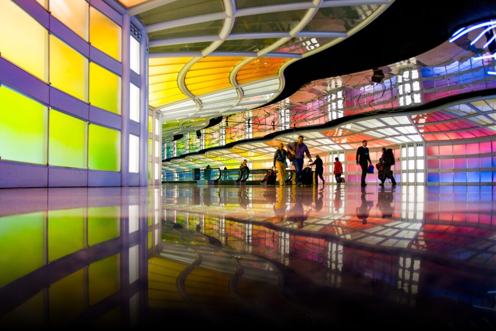 Ey Silhouettes Of Travelers In An Airport Concourse.jpg