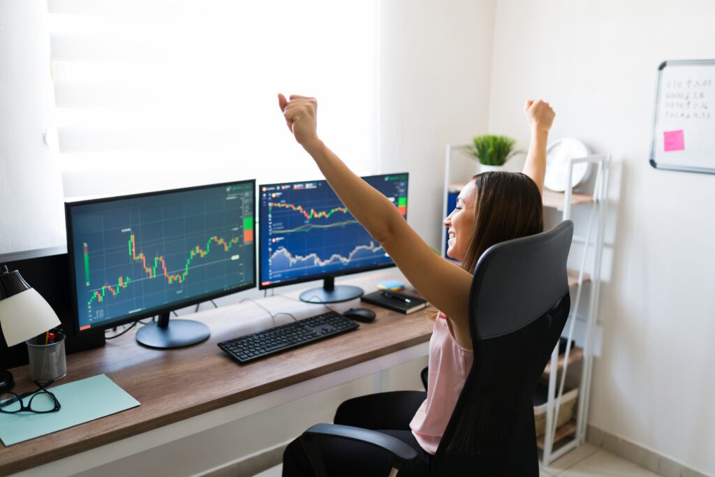 Person Looking At Graphs And Charts Happy Because The Stock Market Went Up.jpg